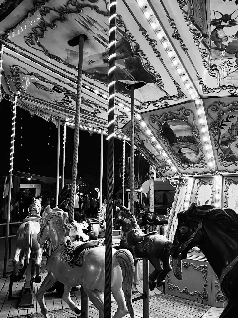 a black and white photo of a merry go round