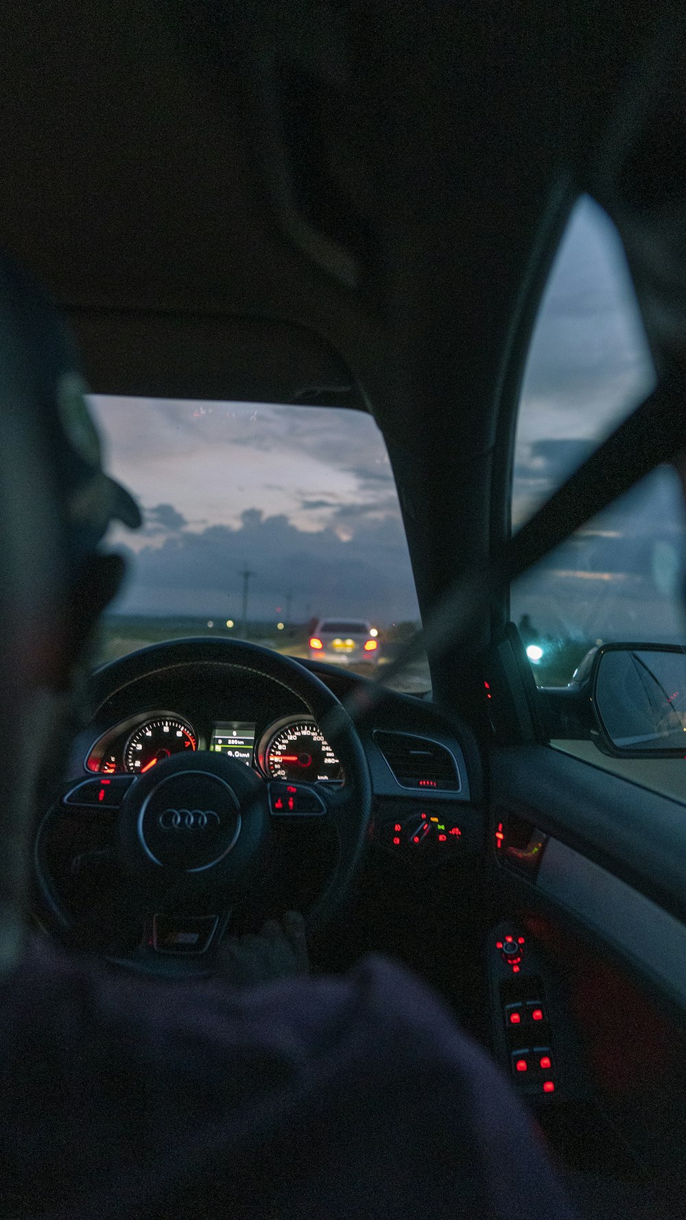 a view of the dashboard of a car at night