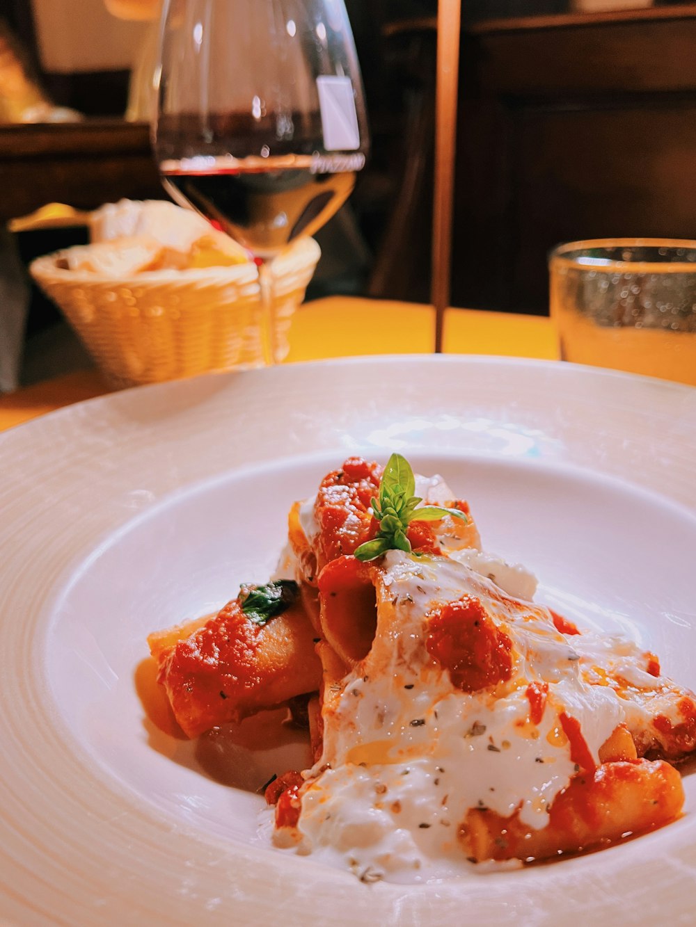 a plate of food on a table with a glass of wine