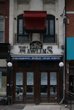 Exterior view of a rustic warehouse in New Orleans' warehouse district with music-themed murals.
