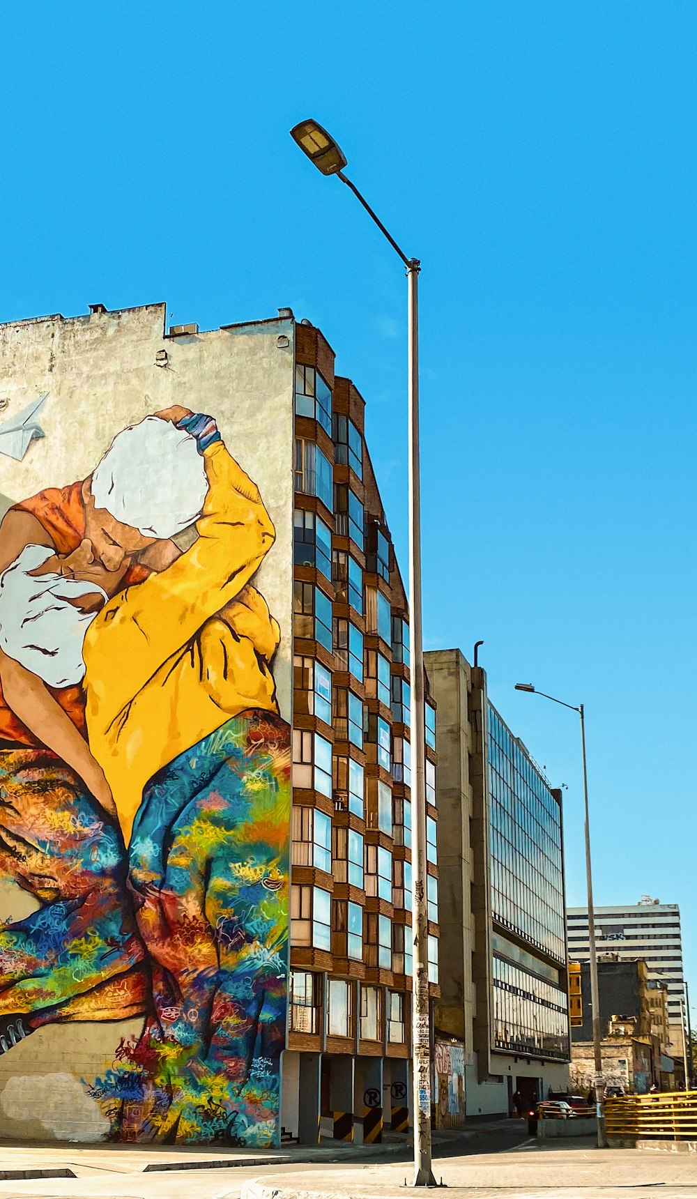 a large mural of a woman with a yellow jacket