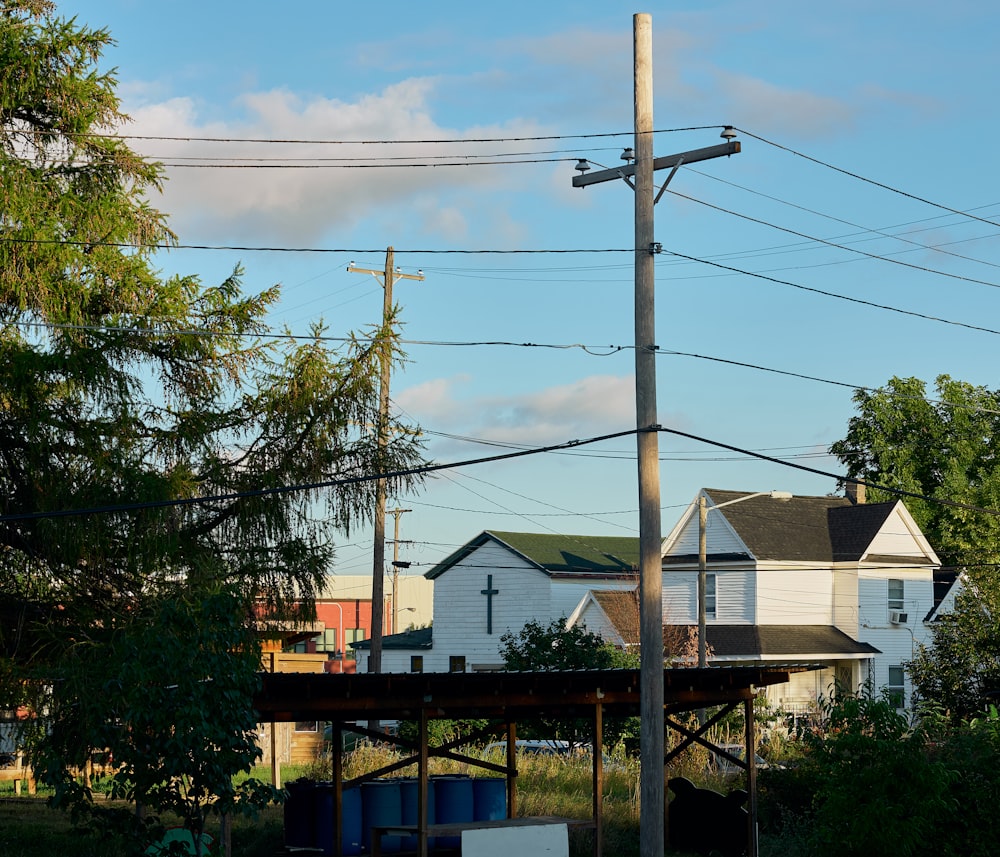 a street sign on a pole in front of a house