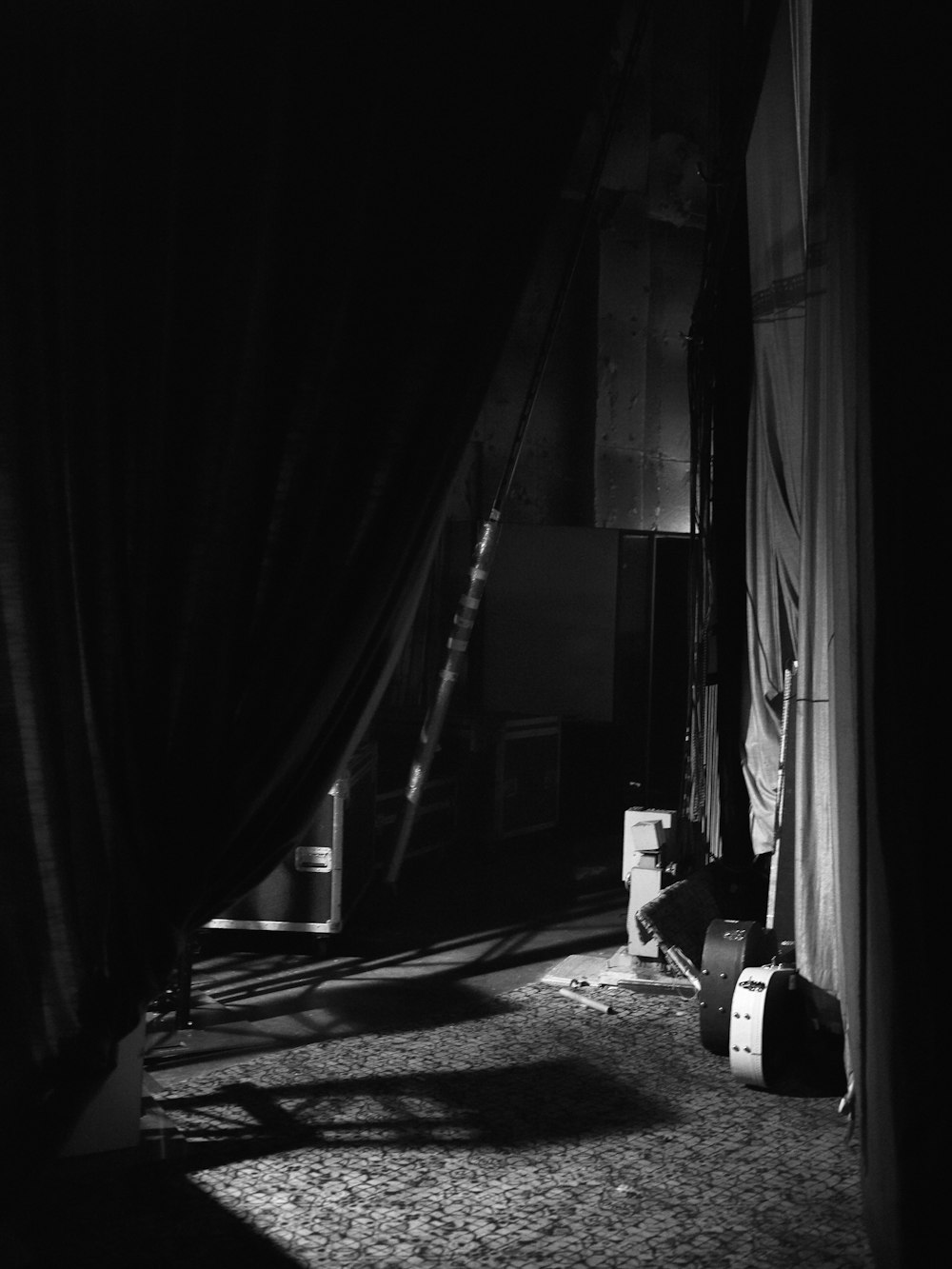 a black and white photo of a room with curtains