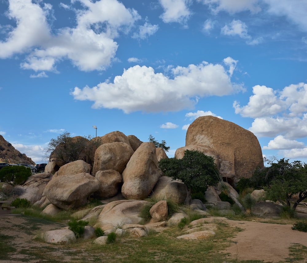 a large rock formation in the middle of a field