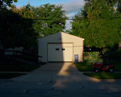 A tidy, cleared-out garage with sunlight streaming through the open door.