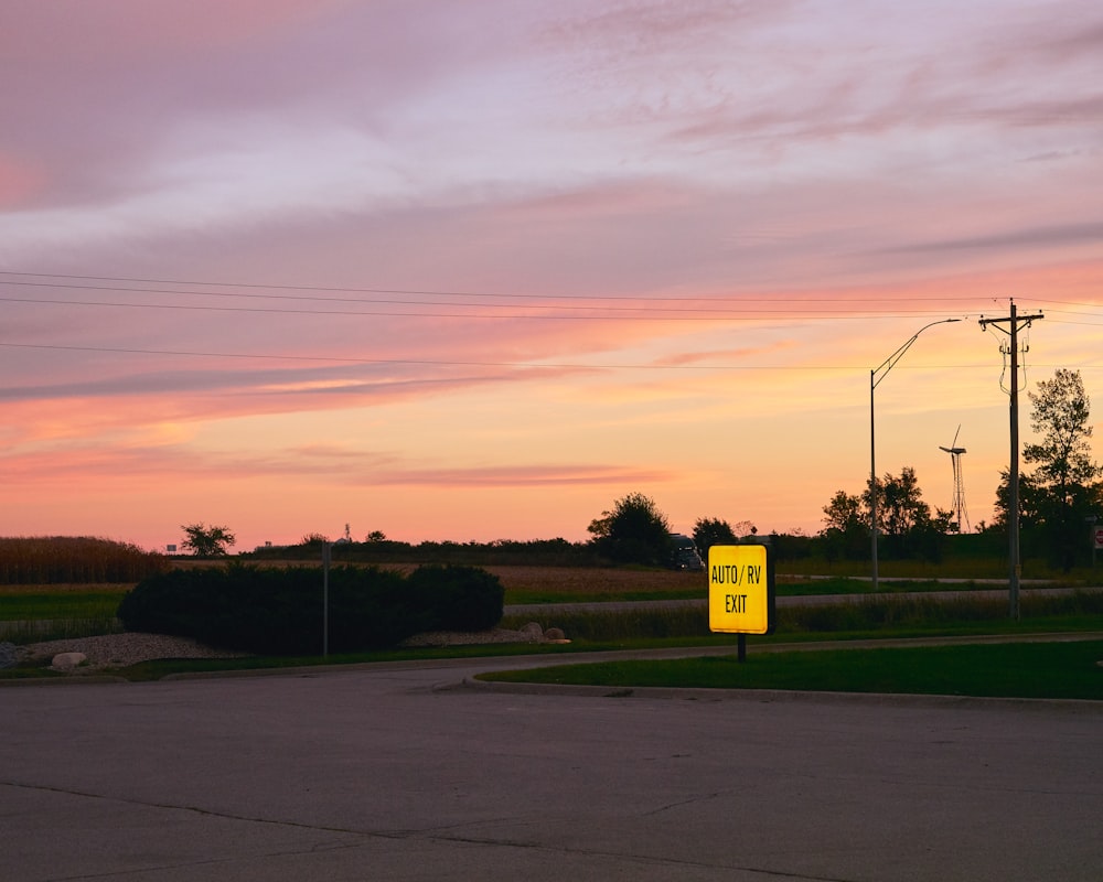 a yellow sign sitting on the side of a road