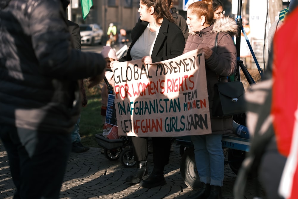 a group of people holding a protest sign