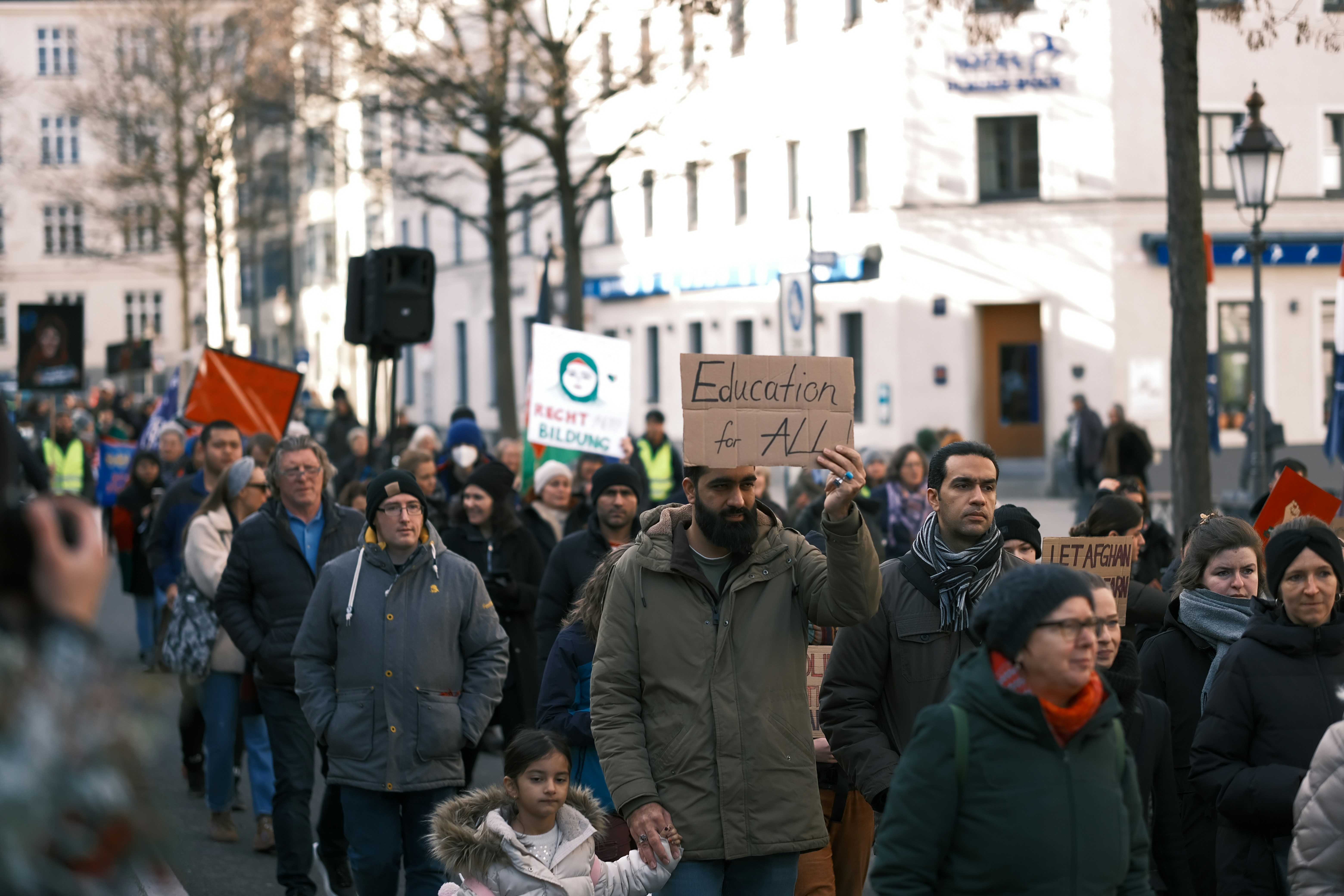 a large group of people walking down a street