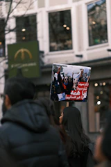 A poignant photograph of an Iranian family holding hands amidst a backdrop of peaceful protest.