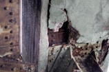 Rusted and deteriorating metal structure with visible corrosion and peeling paint, highlighting significant wear and decay over time.
