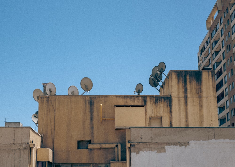 a group of satellite dishes on top of a building