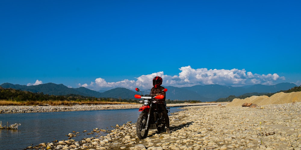 a motorcycle parked on the side of a river