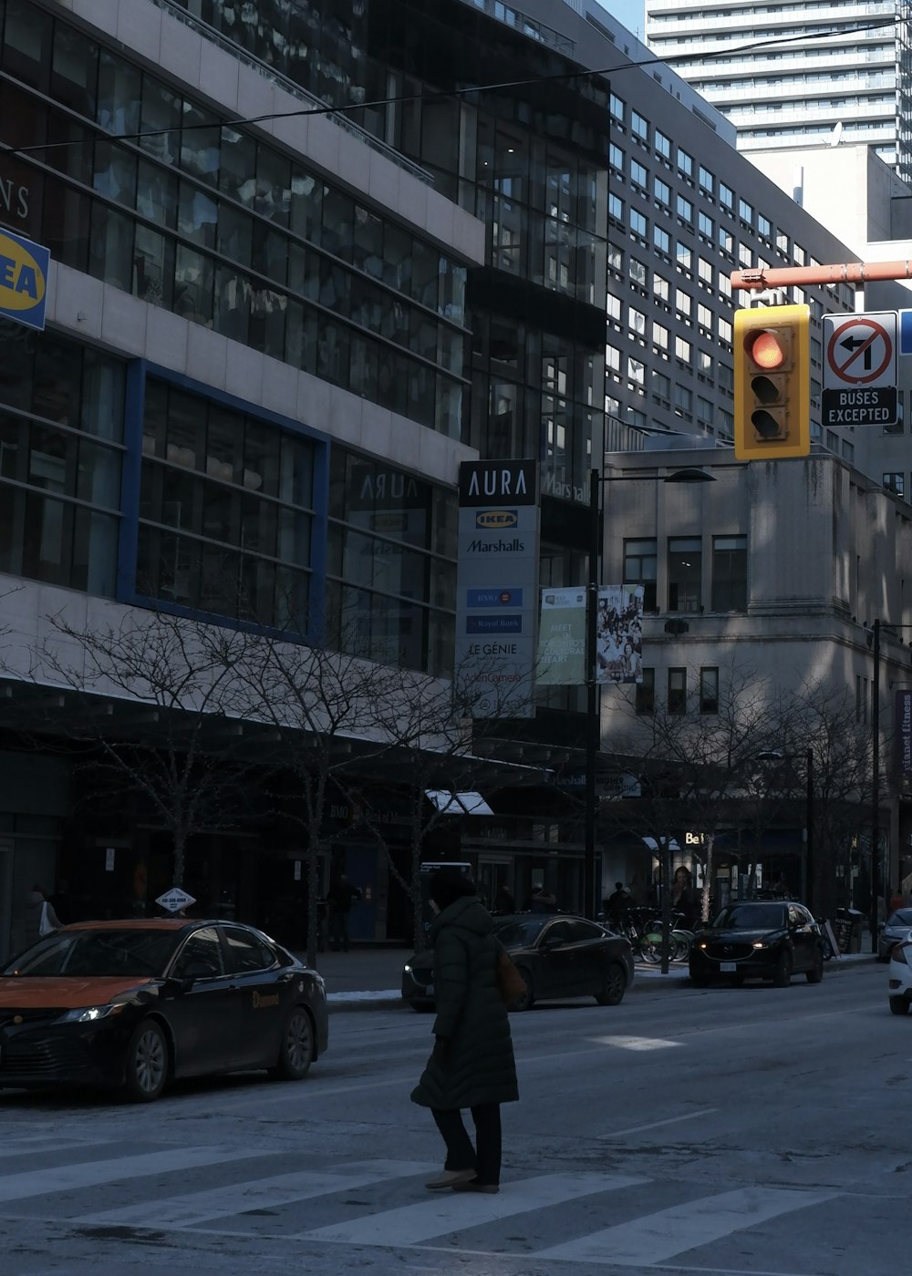 a person walking across a street in a city