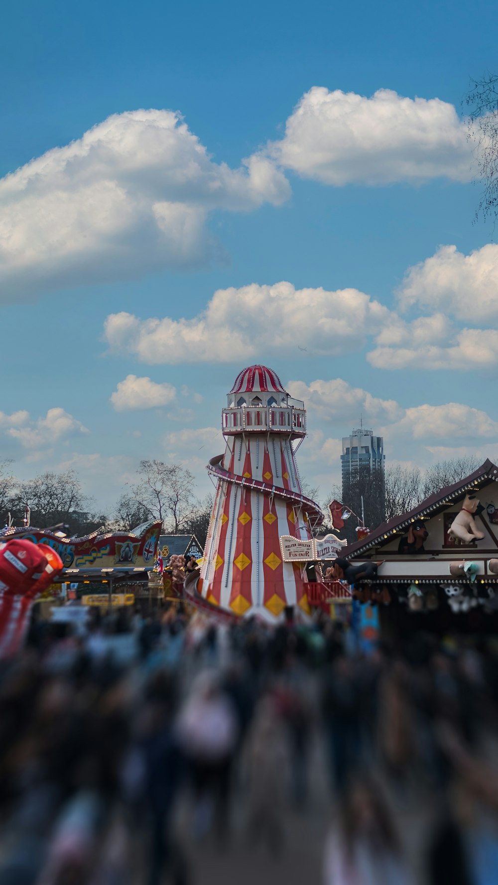 a carnival ride with a crowd of people in the background