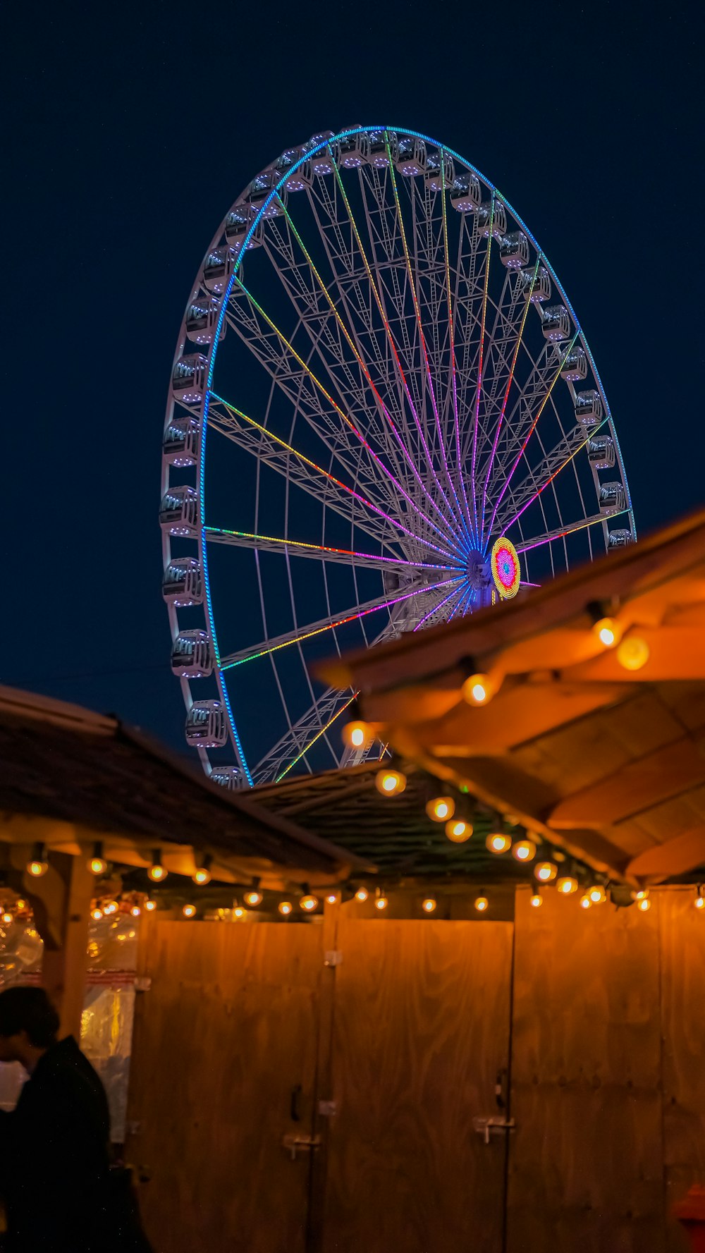 a ferris wheel is lit up at night