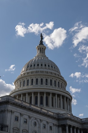 Photograph of the Supreme Court of India building under a clear sky.