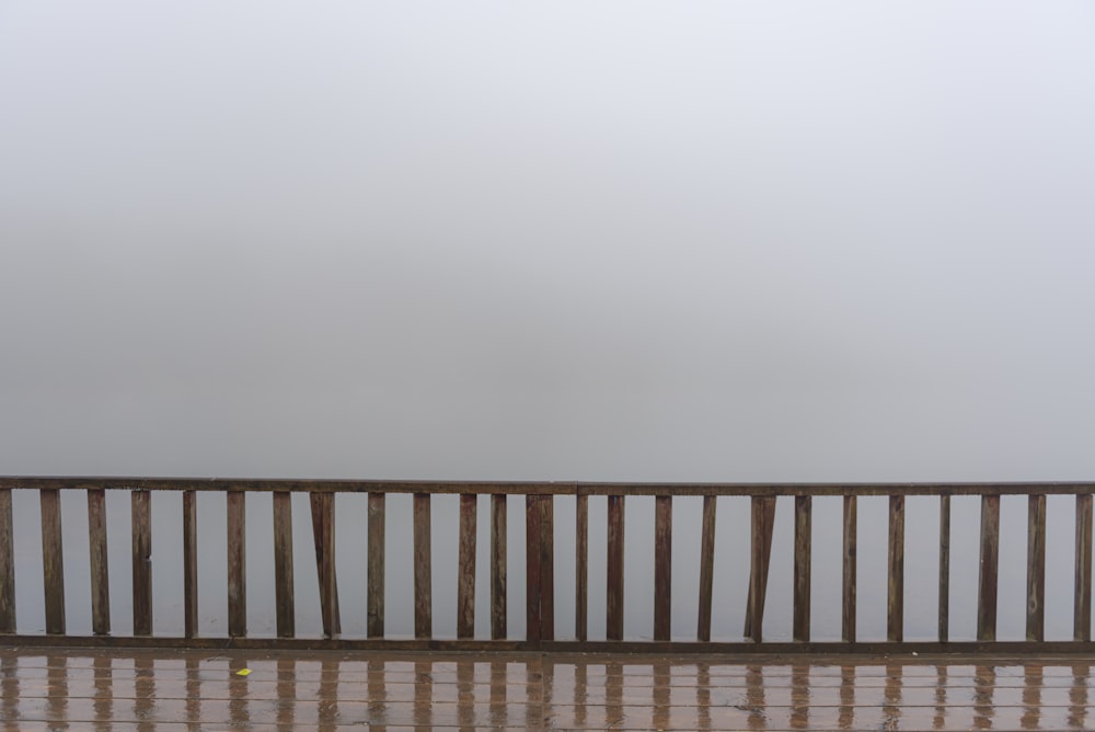 a person standing on a deck with a tennis racket