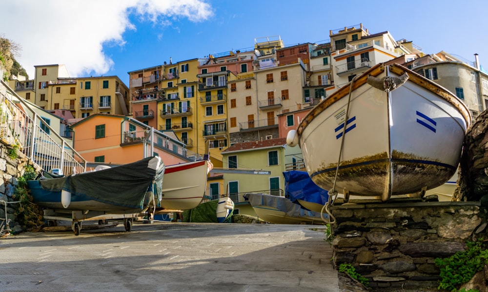 a row of boats sitting on top of a street