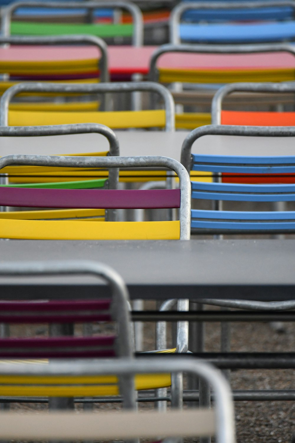 a row of multicolored chairs sitting next to each other