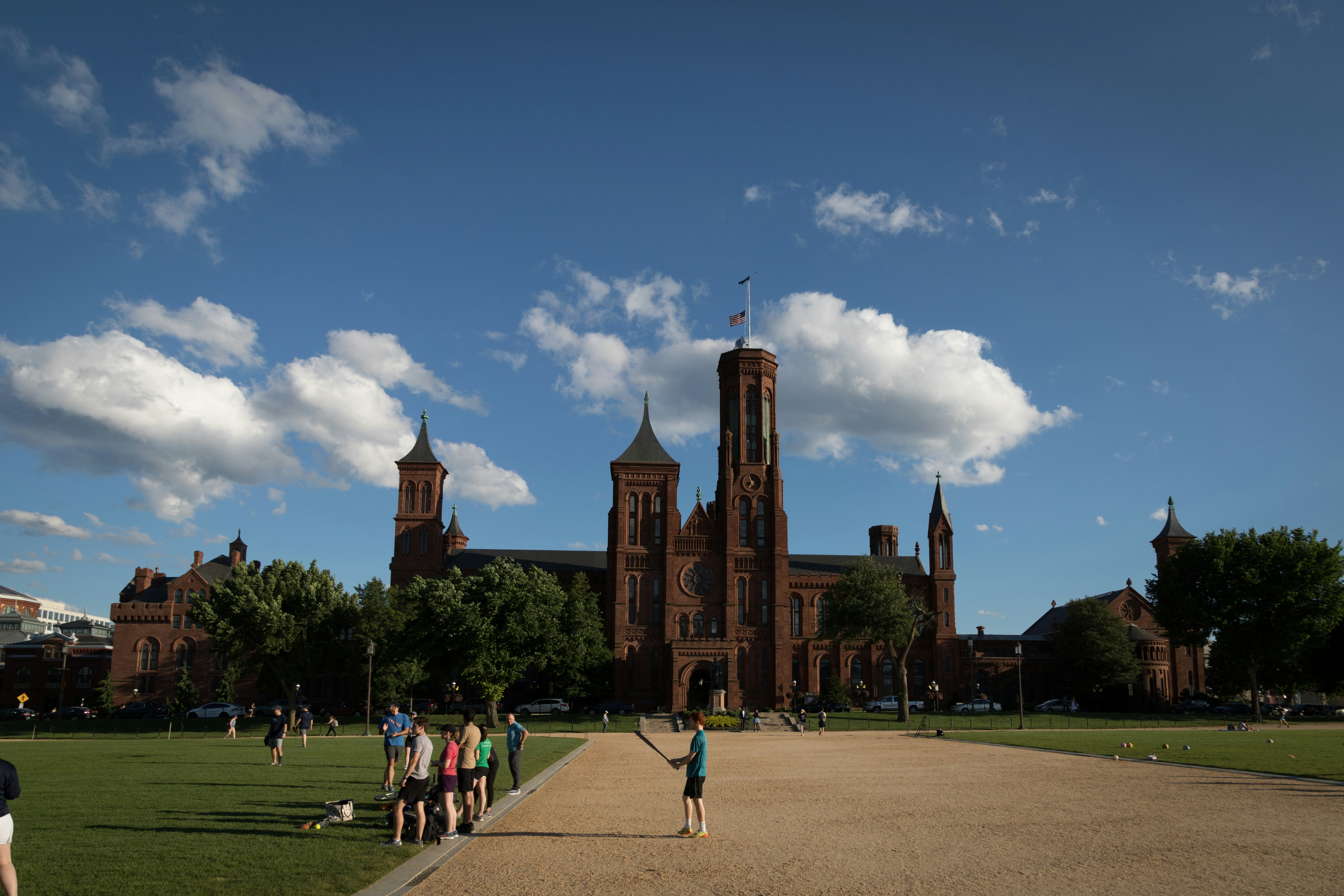 a group of people standing in front of a large building