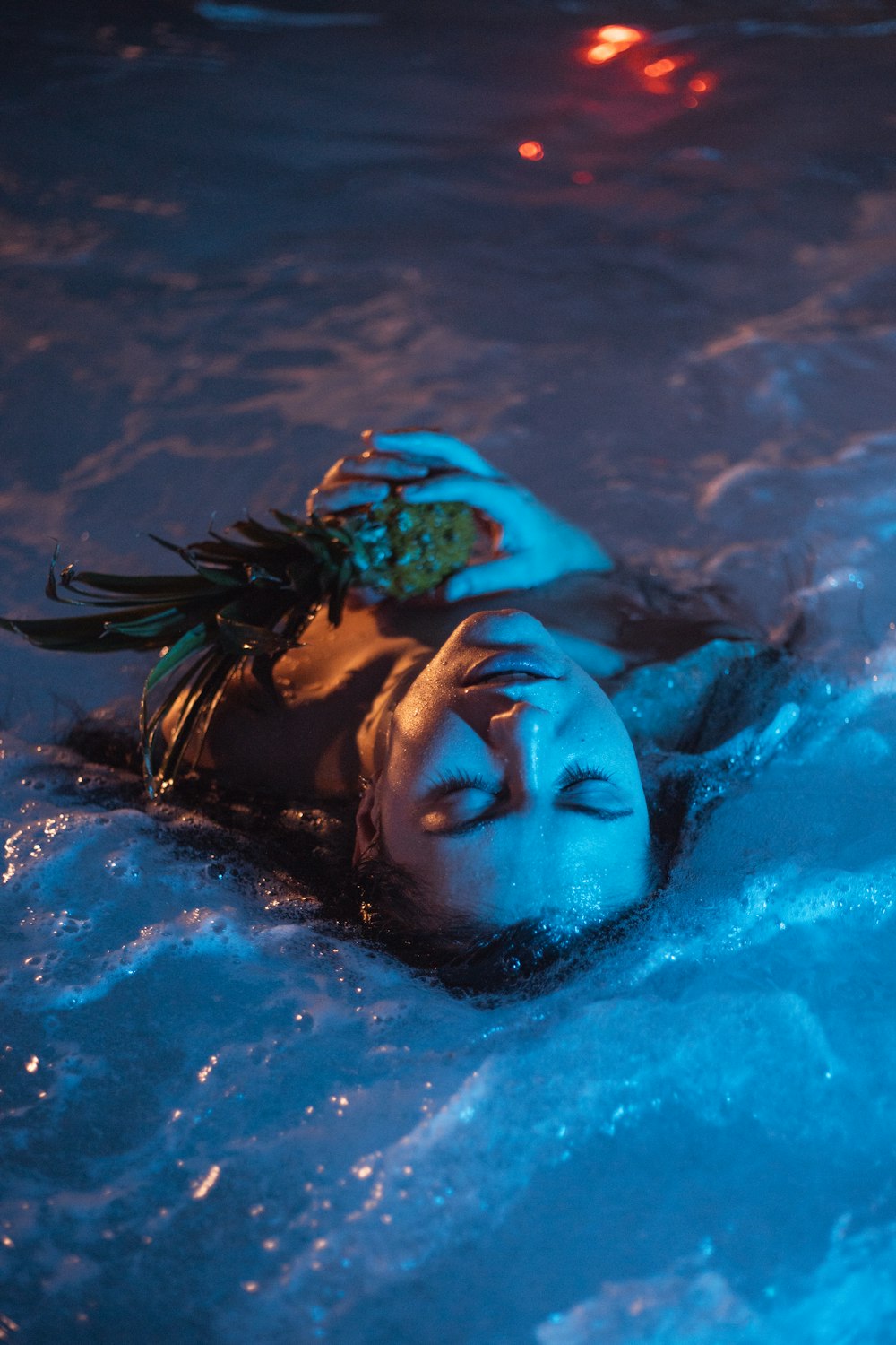 a woman is floating in a pool of water