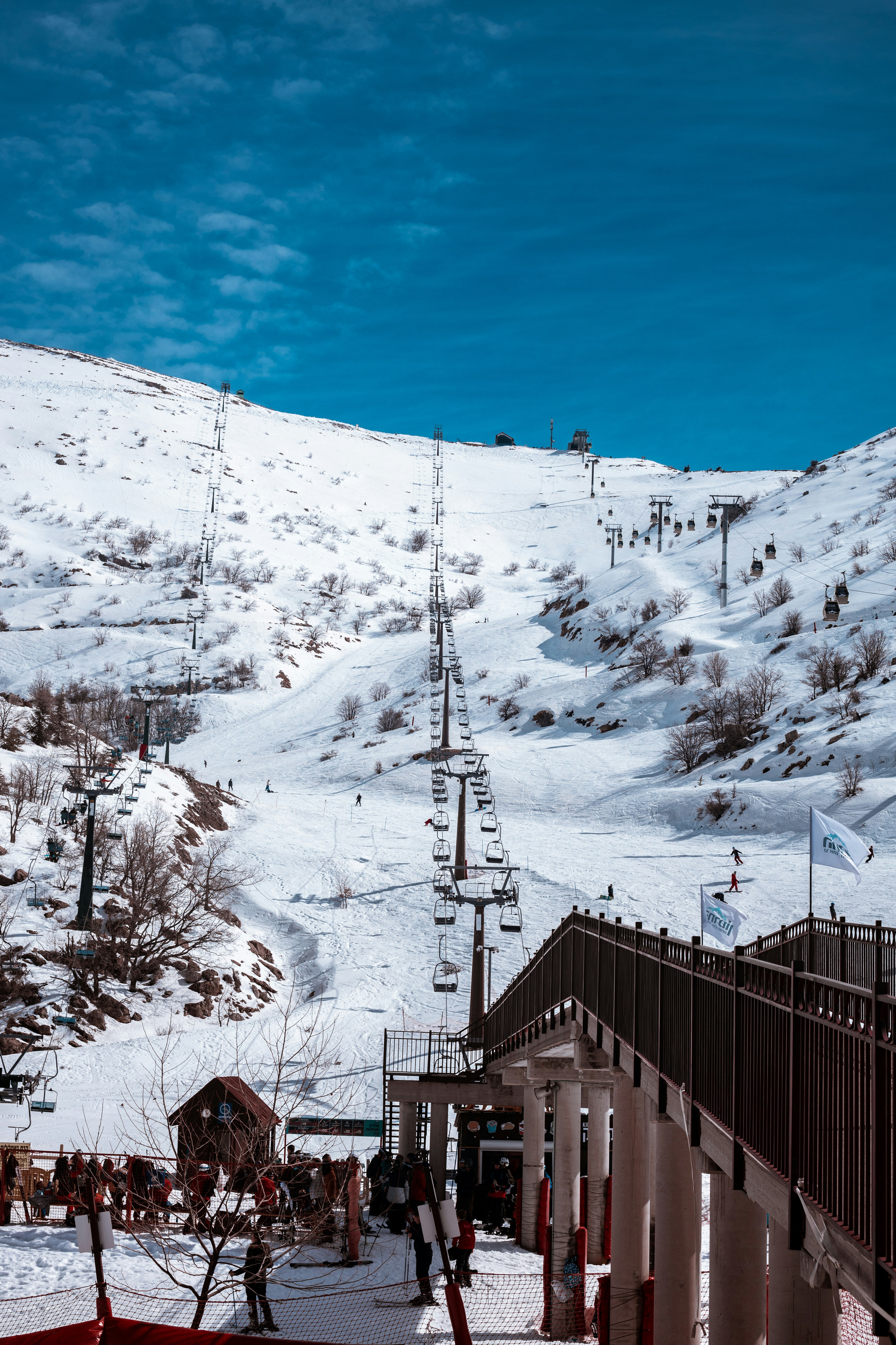 a snow covered mountain with a ski lift in the distance