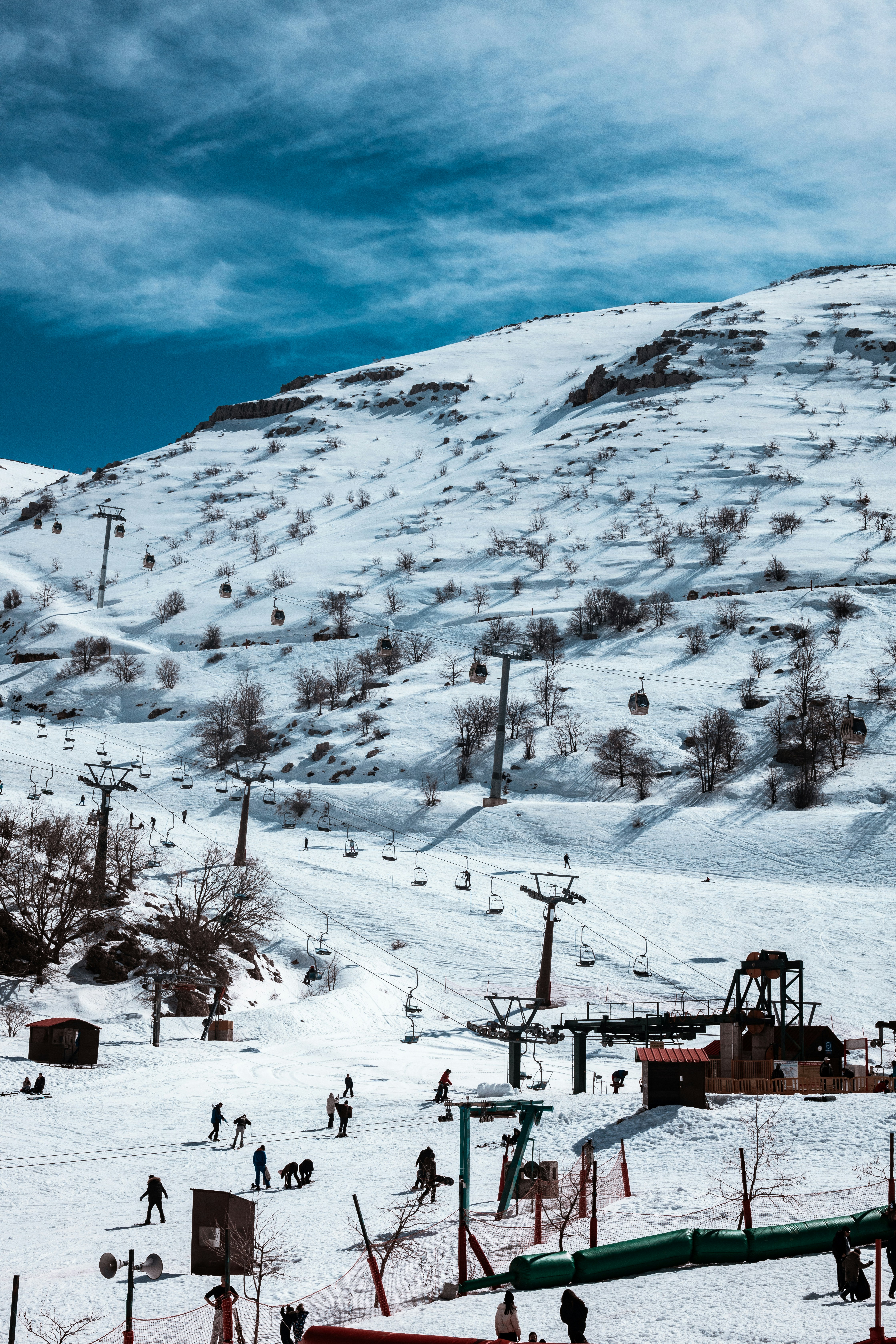 a group of people riding skis down a snow covered slope