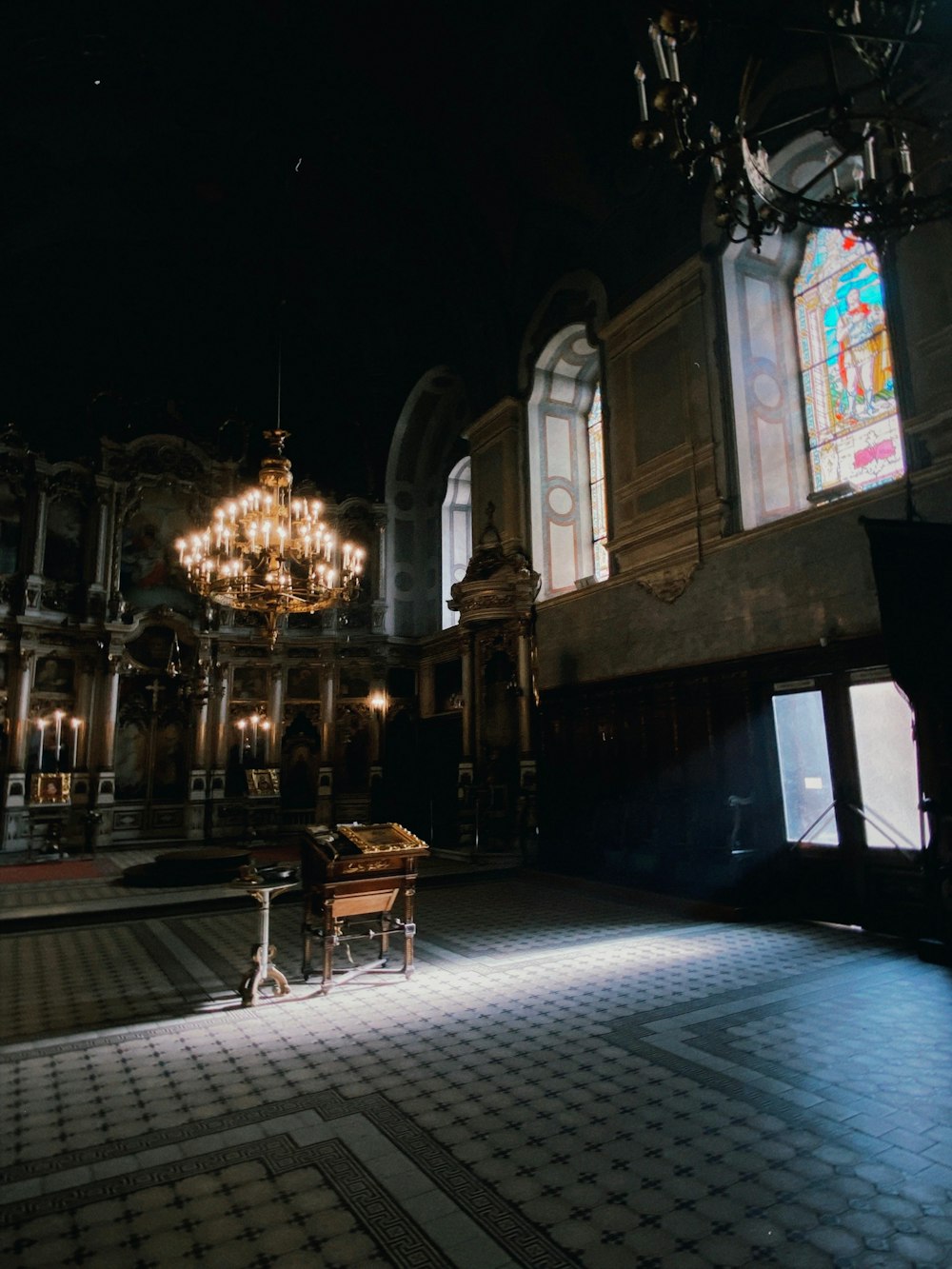 a room with a chandelier and a piano in it