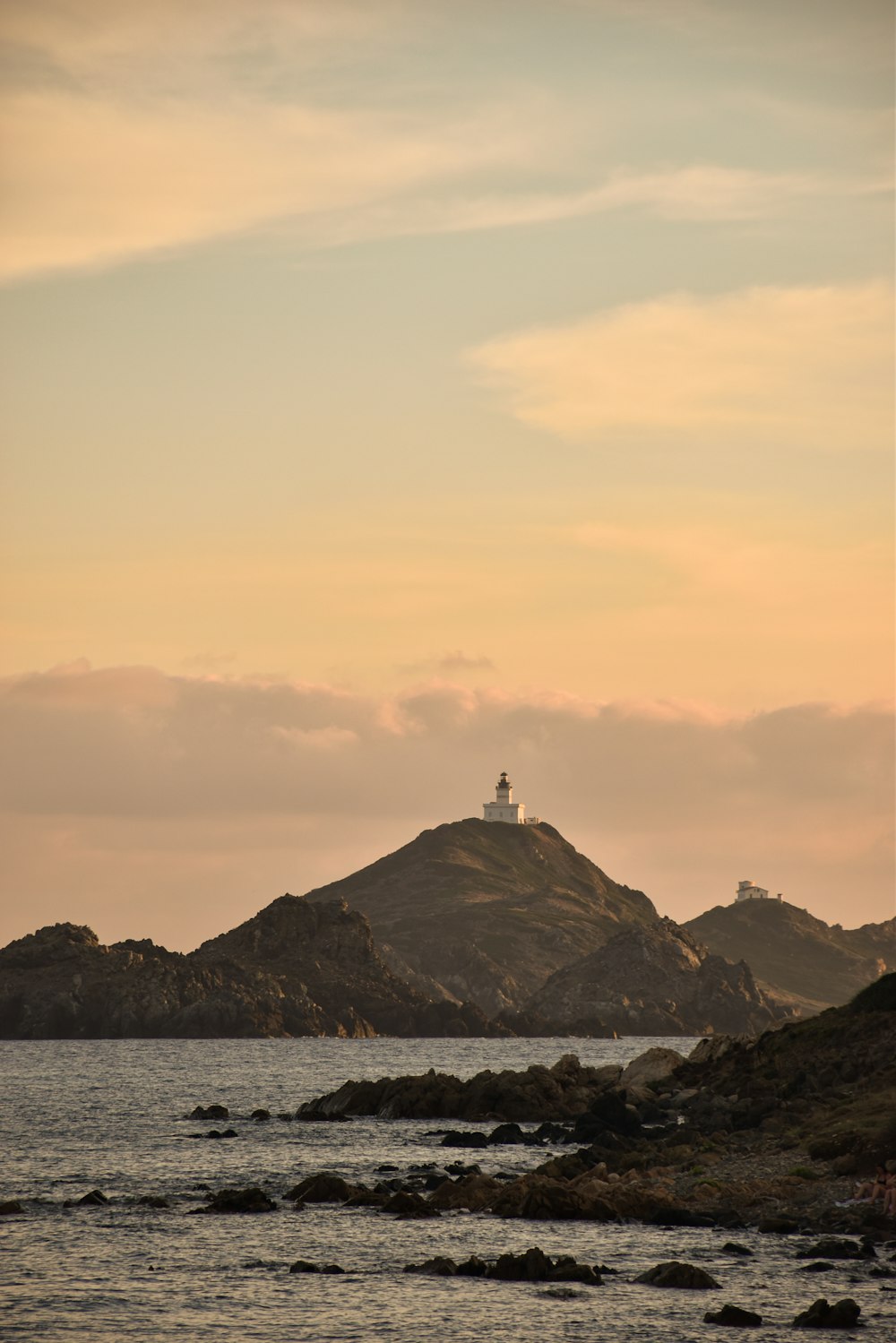 a lighthouse on a small island in the middle of the ocean