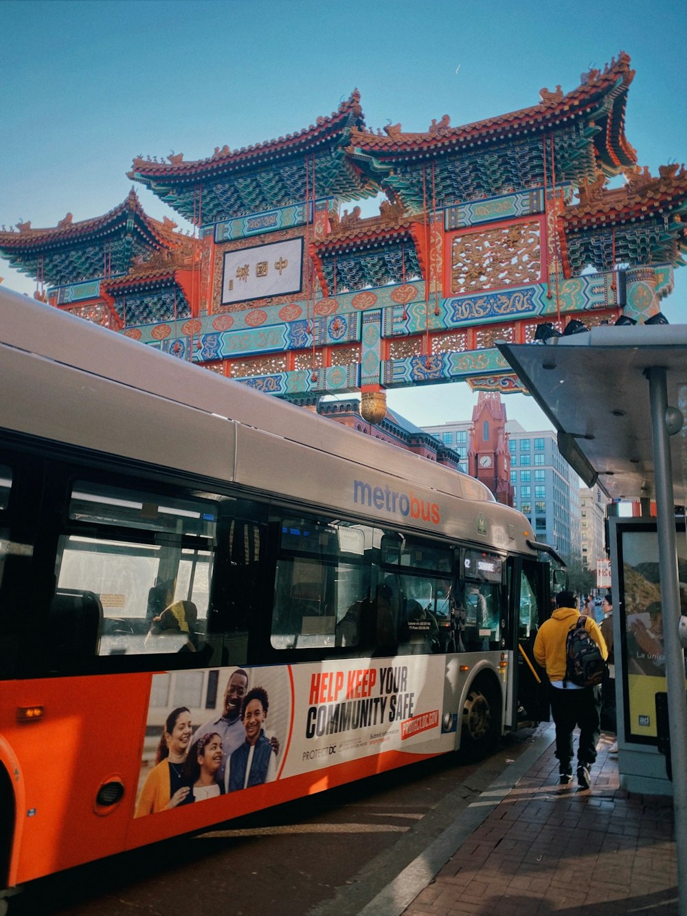 a bus parked in front of a building under a bridge