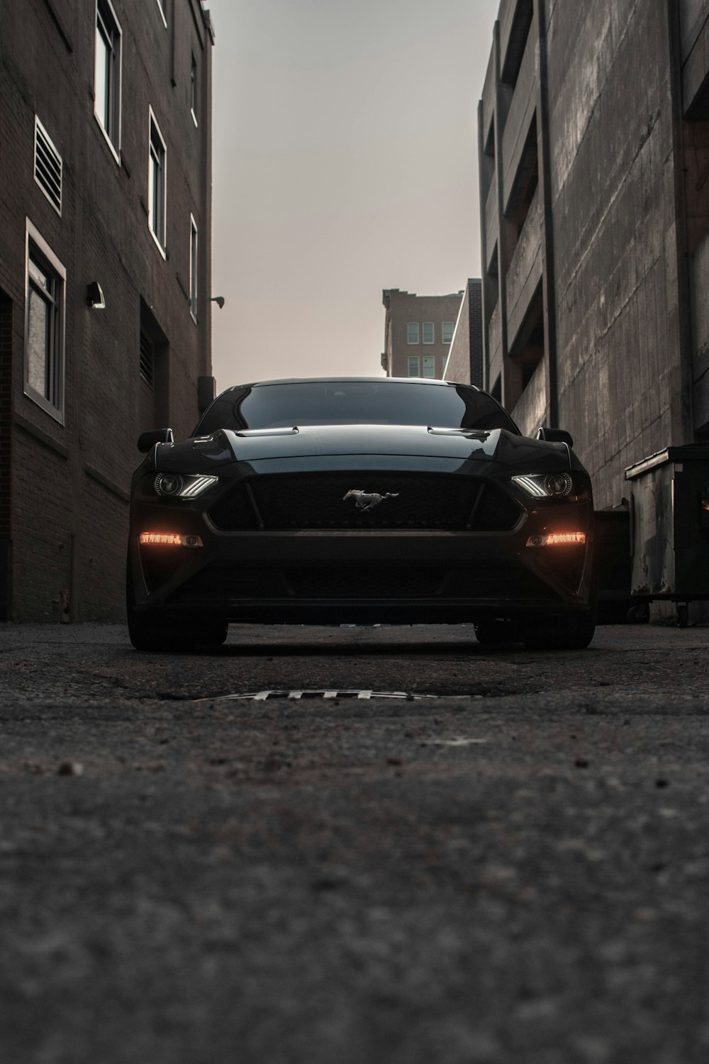a black sports car parked in an alley