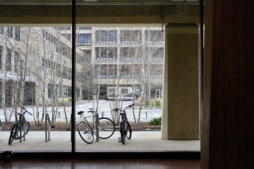 a couple of bikes are parked outside of a building