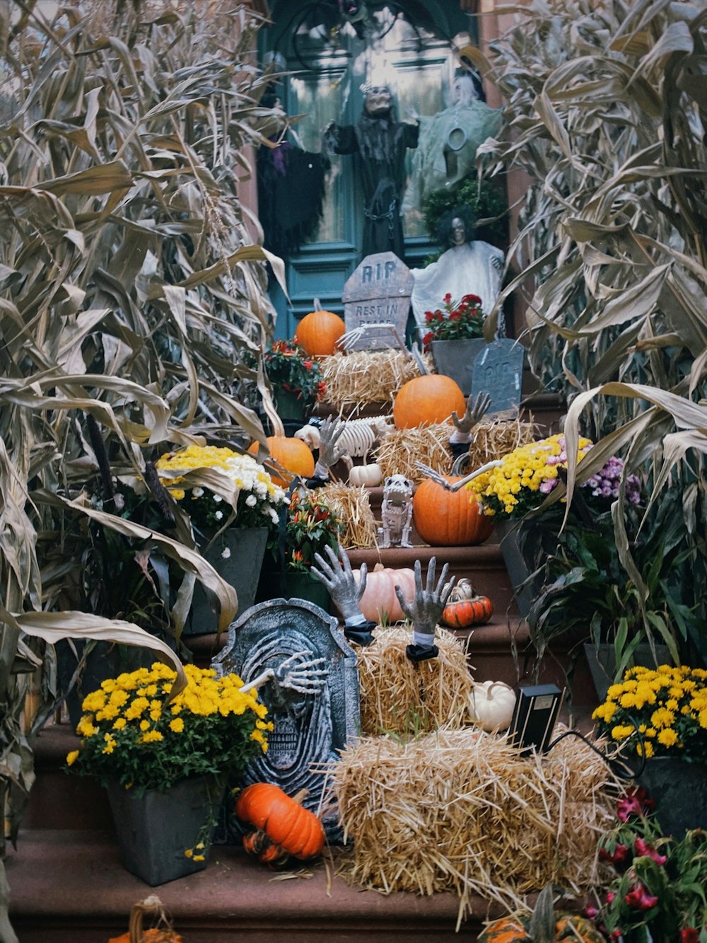 a set of steps covered in hay and pumpkins