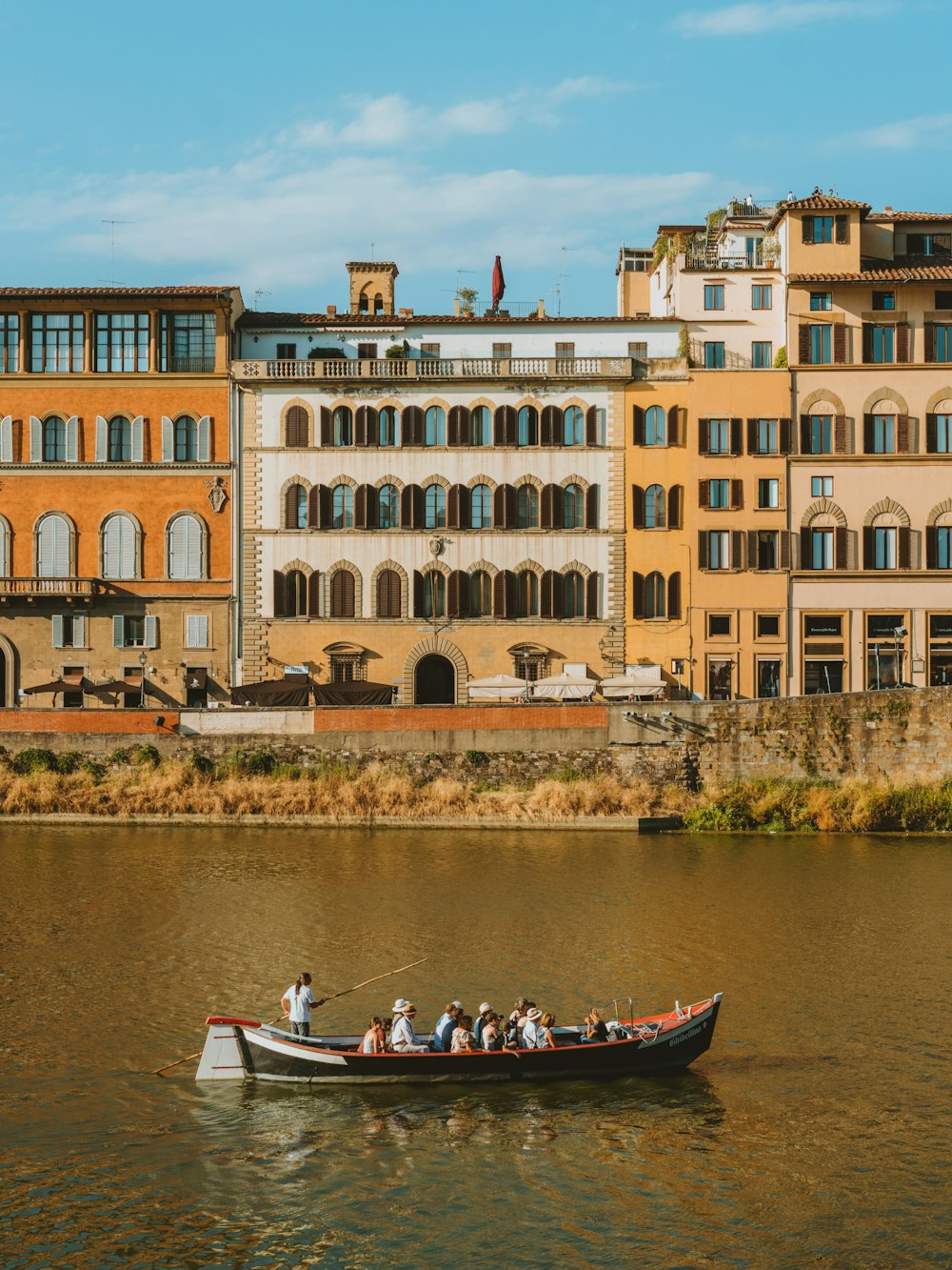 a group of people in a small boat on a body of water