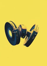 Abstract illustration of interconnected gears glowing in deep purple and yellow hues.