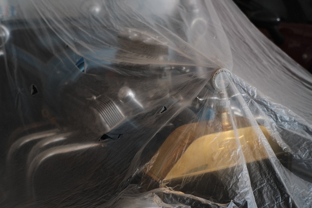 a yellow and black object wrapped in plastic