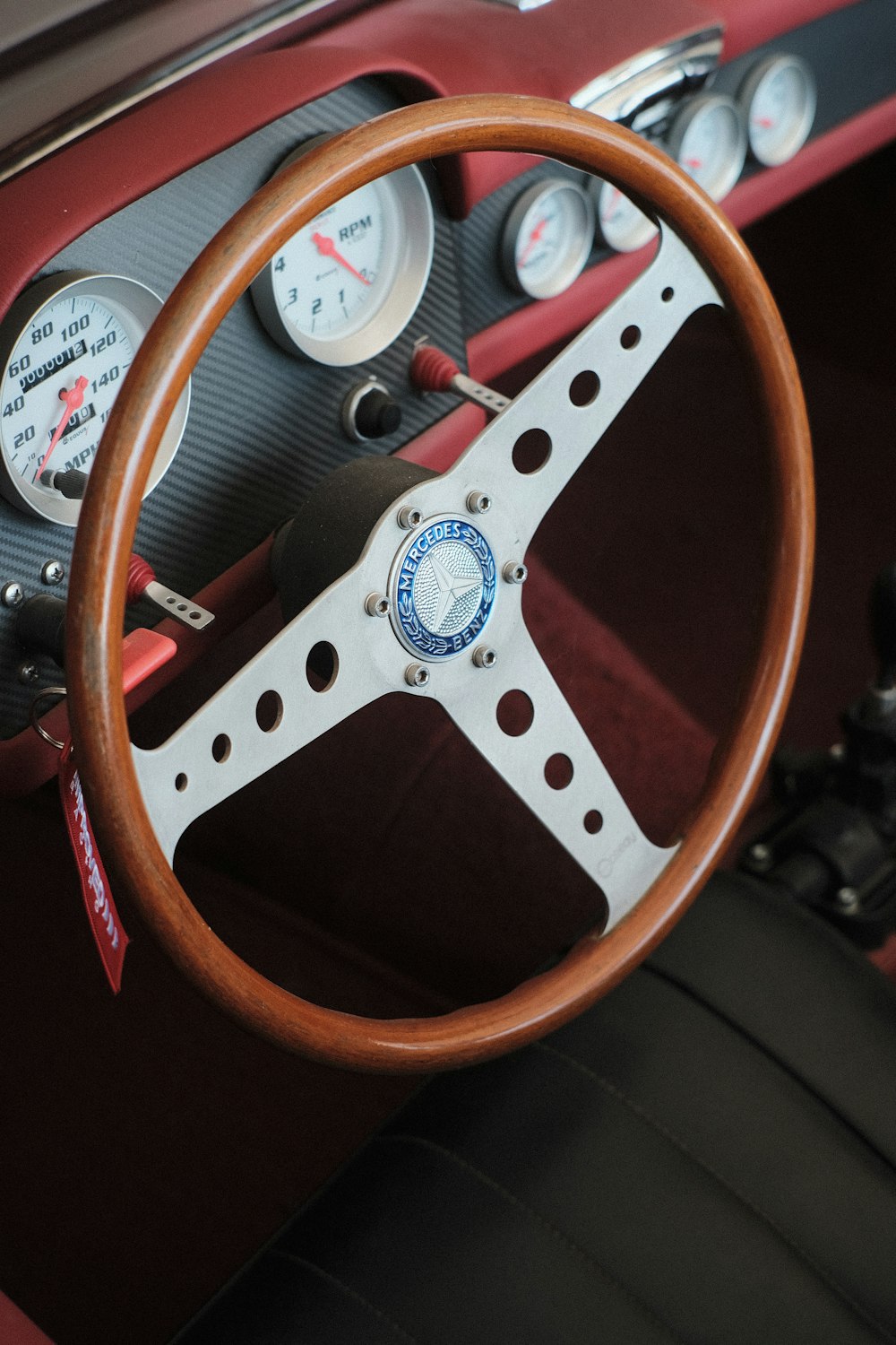 a steering wheel and dashboard of a classic car