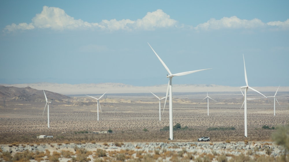 a group of wind turbines in a desert