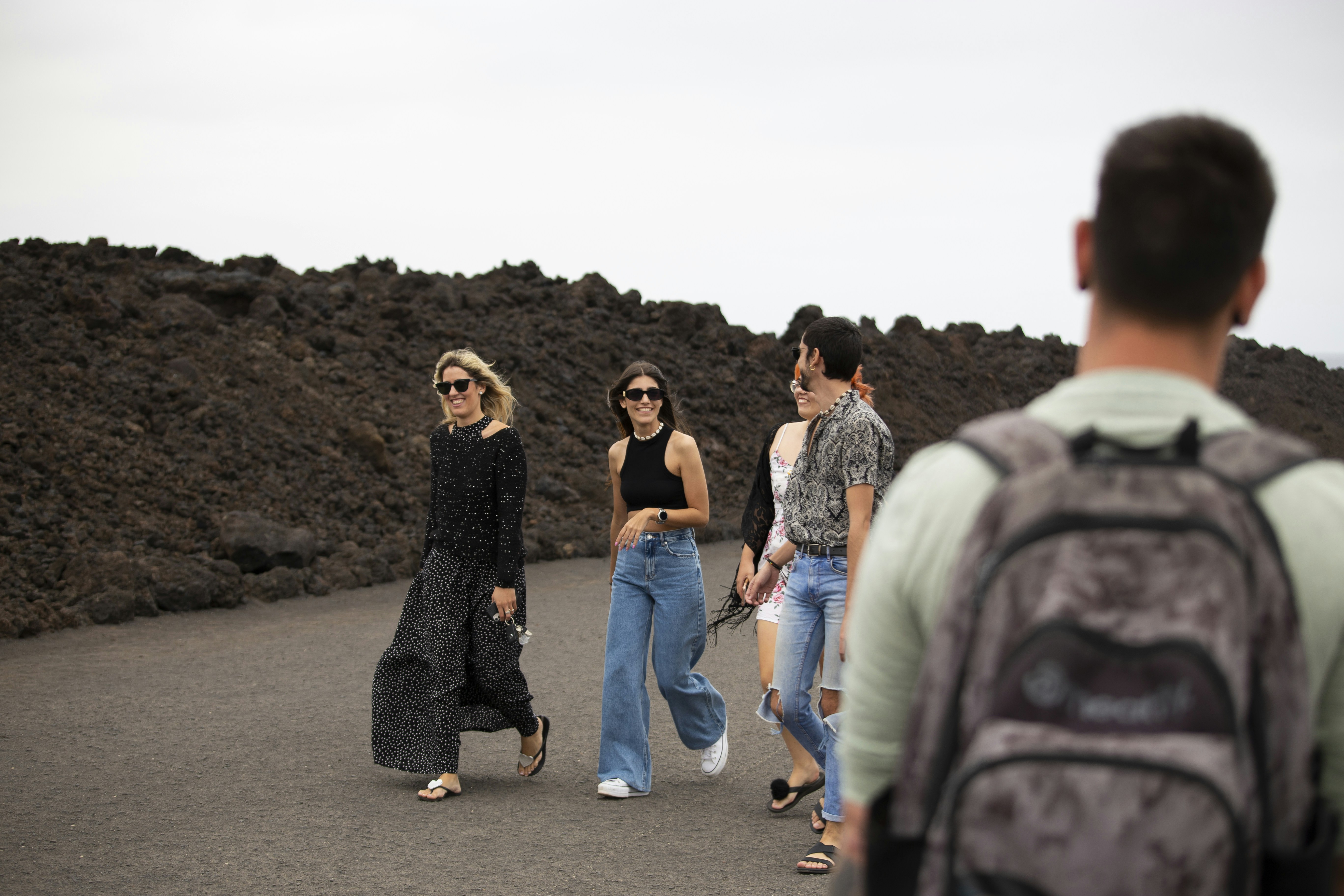 a group of people walking down a road