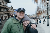 Snow-covered Canadian neighborhood with people walking cheerfully in winter coats.