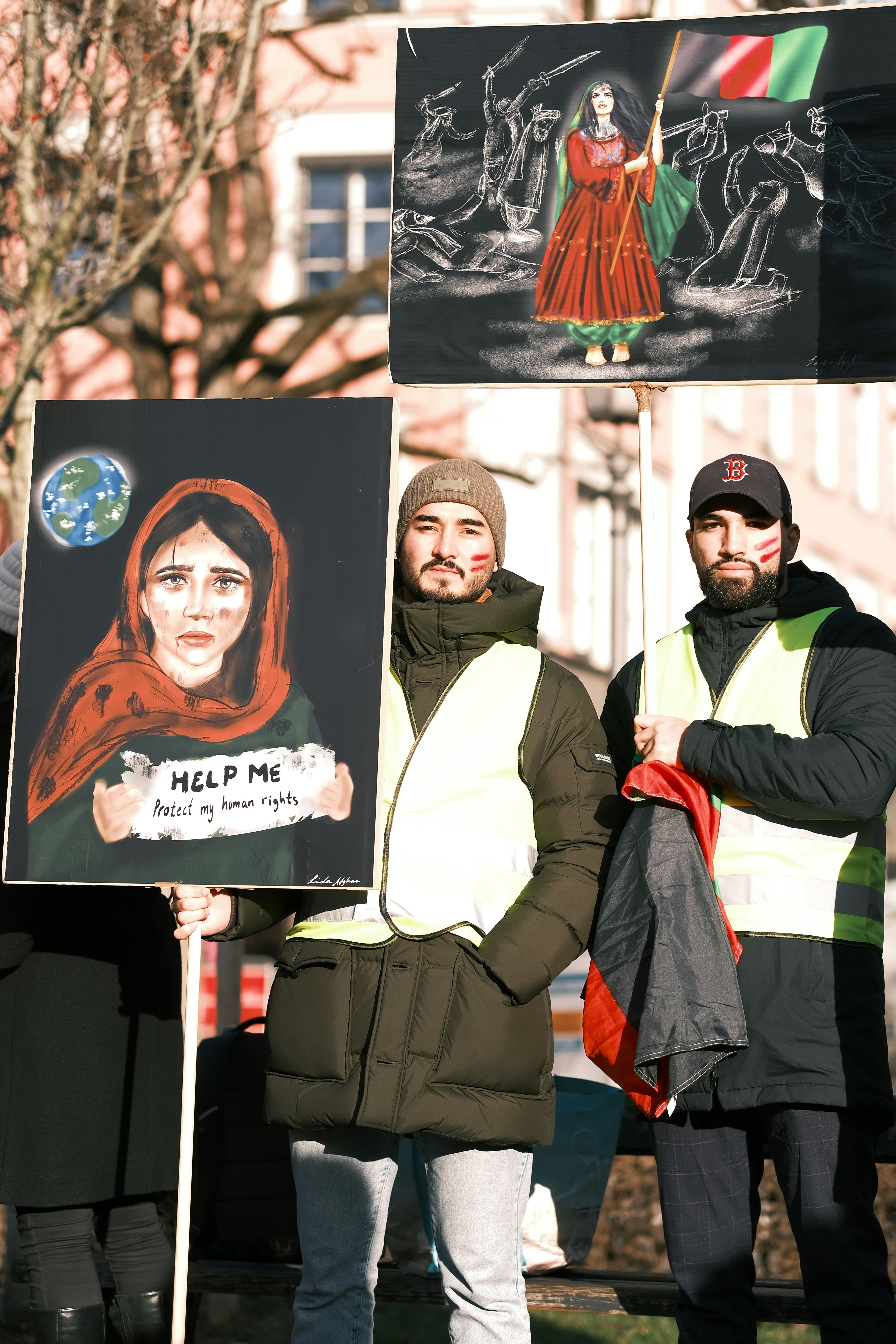 a group of people holding signs in front of a building