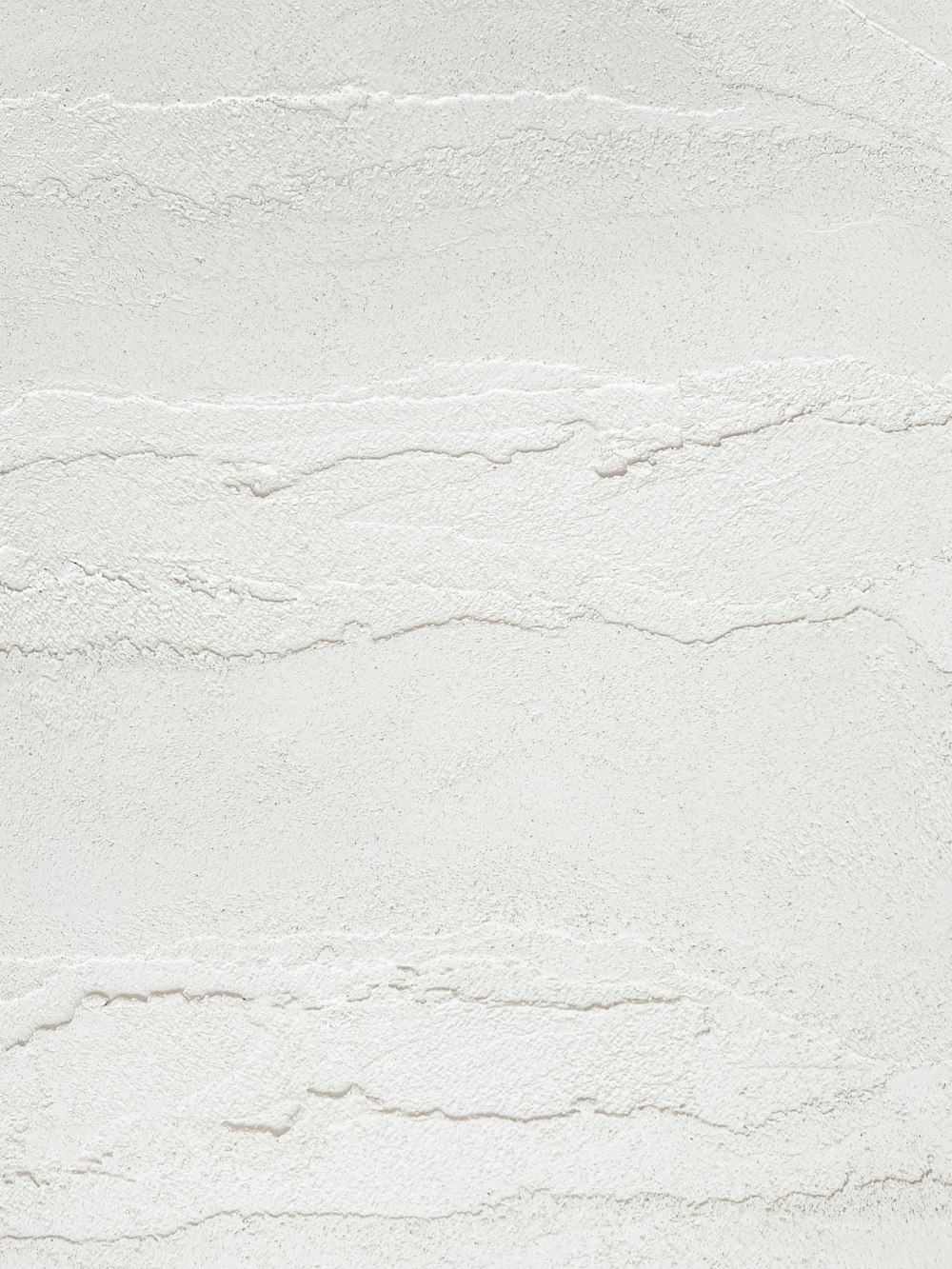 a white textured wall with a white background