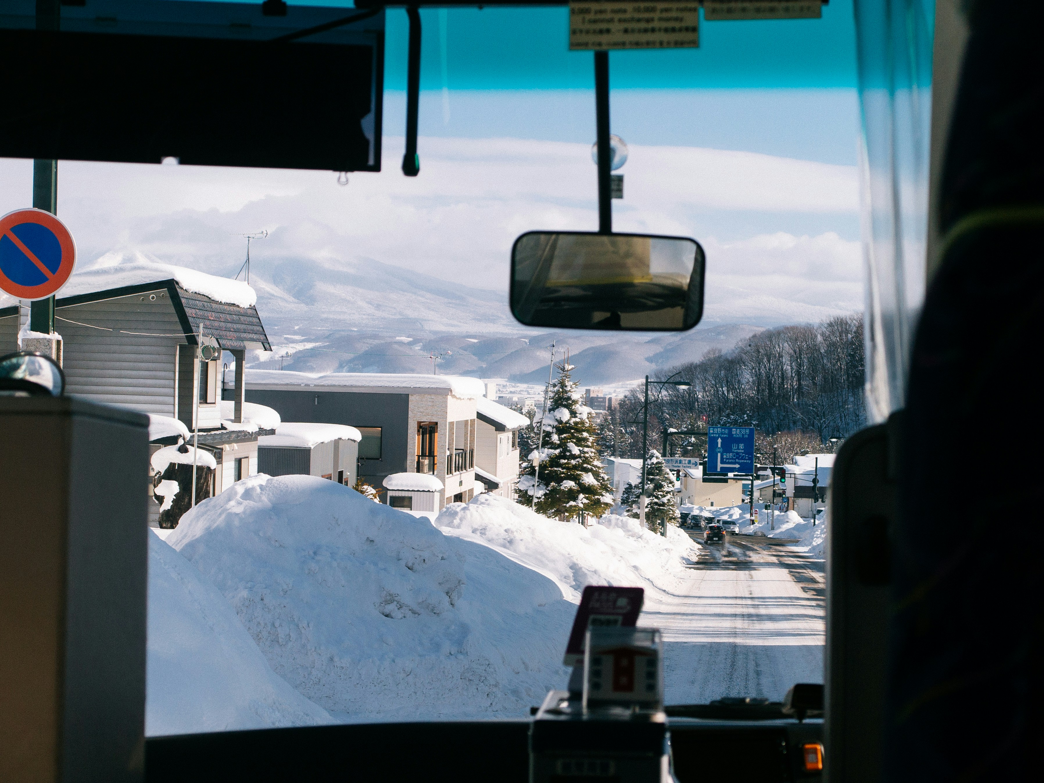 a view from inside a vehicle of a snowy street