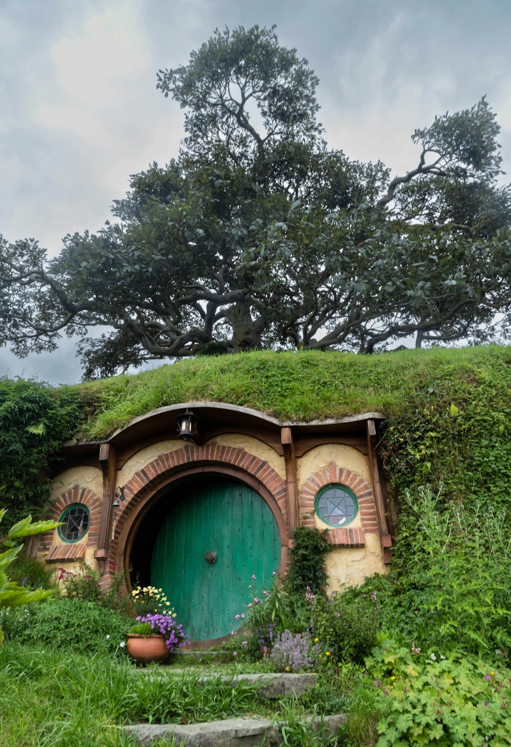 a hobbot with a green door surrounded by greenery