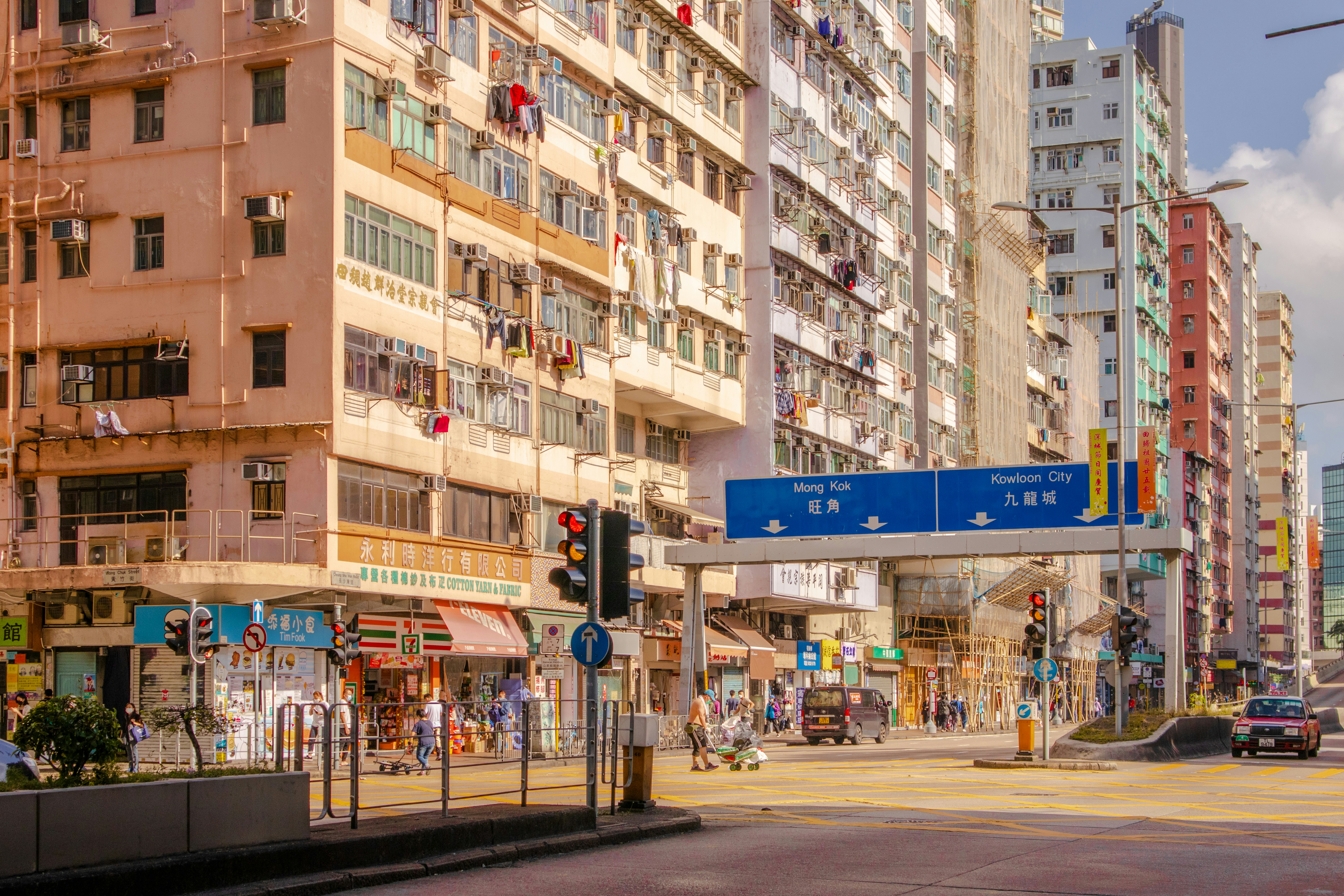 a city street with tall buildings and a traffic light