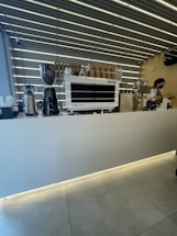 A sleek Sunday Coffee self-service station in a bright, modern office lobby.