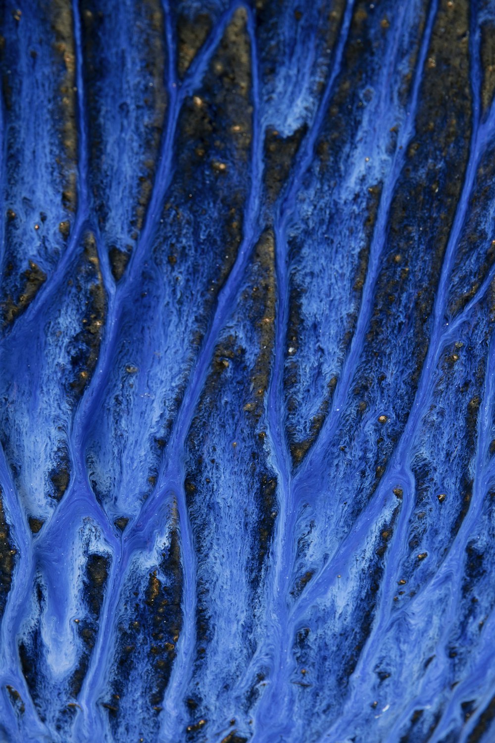 a close up of a blue substance on a surface