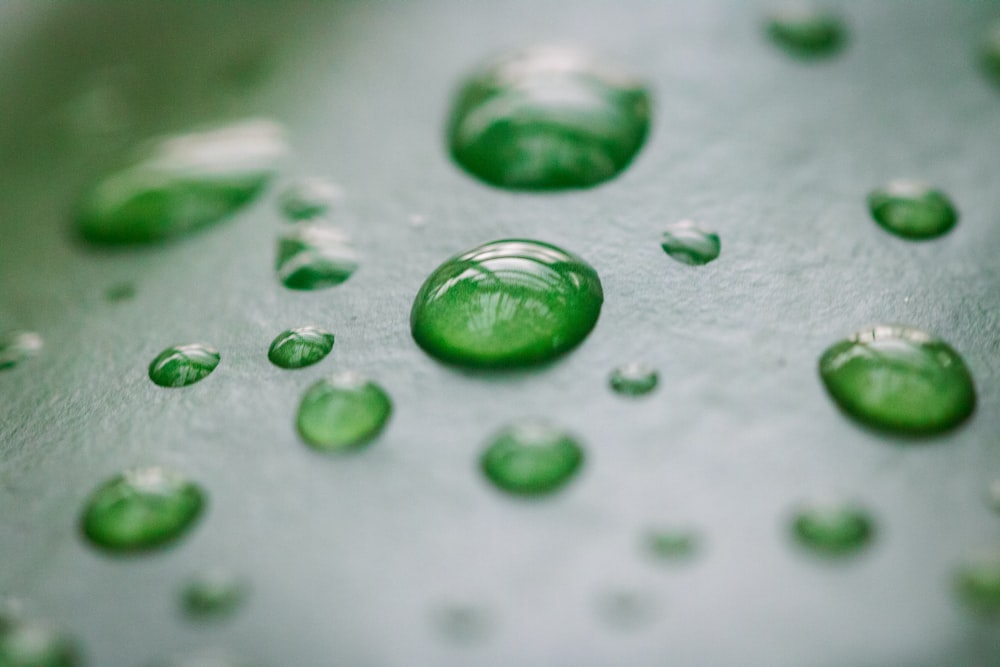 a close up of water droplets on a metal surface