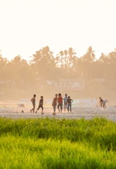 Young athletes practicing soccer drills on a sunny Miami field.