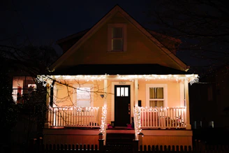 Cozy guest house exterior with welcoming lights at dusk in Srirangam.
